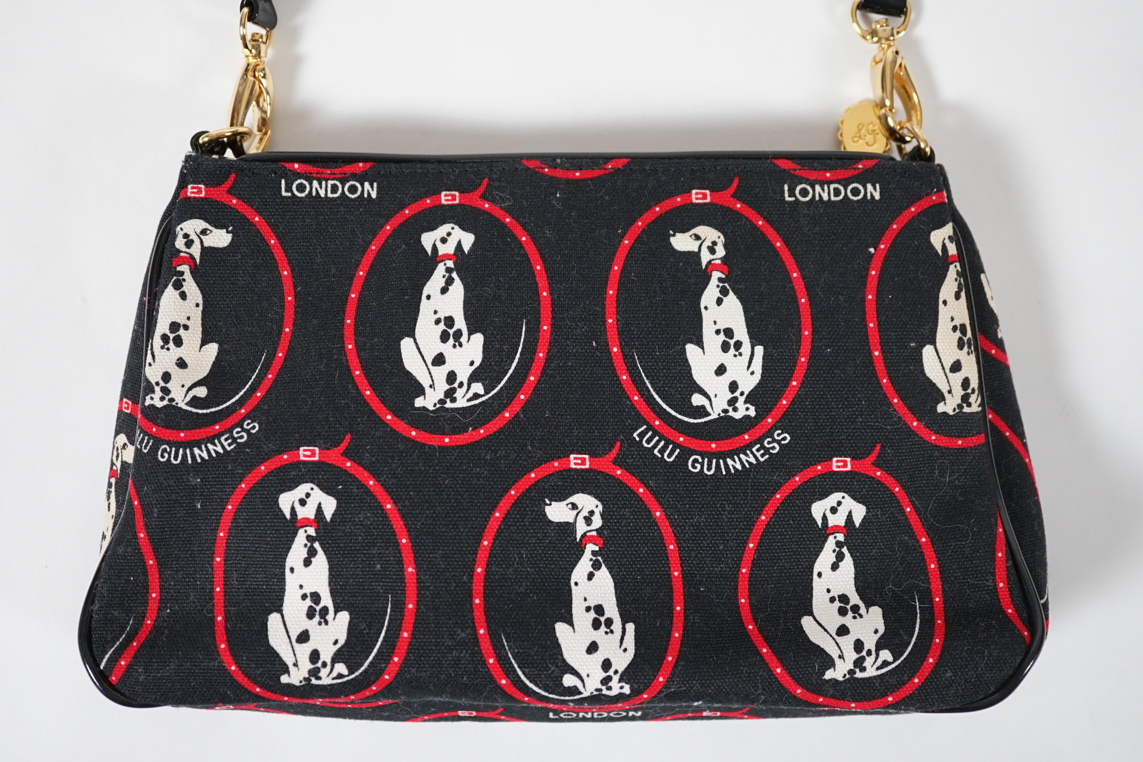 A vintage Lulu Guinness black canvas Dalmatian handbag with black patent leather strap and piping, height 15cm, height to strap 37cm, width 24cm, depth 5cm